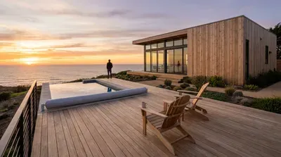 Modern house with ocean view and pool at sunset