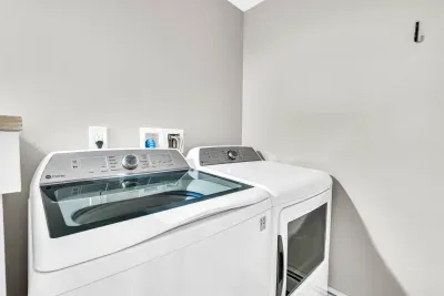 The downstairs full bathroom also offers a high capacity laundry machine and dryer!