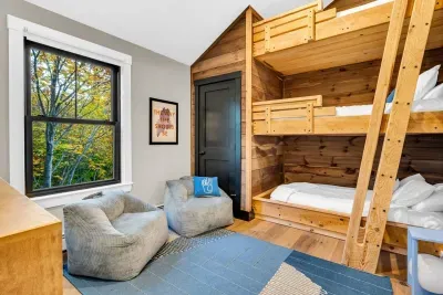 With soaring ceilings, a custom triple bunk bed has been constructed in the upstairs kids room! Each bunk is a single sixed bed!  This room also has an ensuite full bathroom for guests!