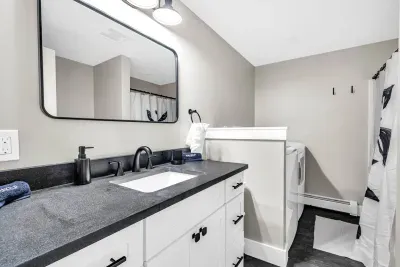 The downstairs full bathroom also offers a high capacity laundry machine and dryer!