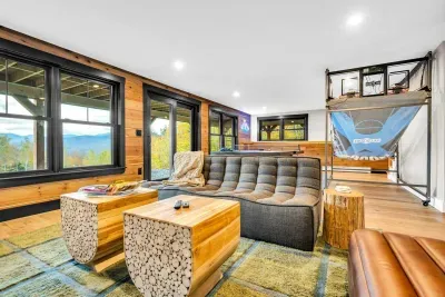 As we head downstairs, you'll be greated by the welcoming downstairs living room with a game space, Smart HDTV, fireplace, and bedrooms!...oh.. and the AMAZING VIEWS!