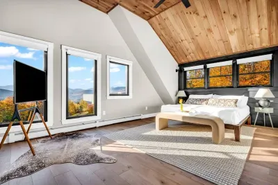 This primary bedroom offers breathtaking views of Sunday River and the surrounding mountains!