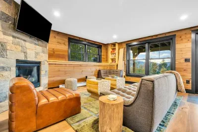 As we head downstairs, you'll be greated by the welcoming downstairs living room with a game space, Smart HDTV, fireplace, and bedrooms!...oh.. and the AMAZING VIEWS!