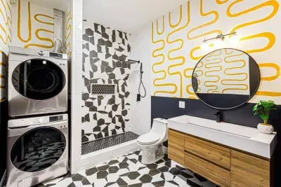 This gorgeously styled full bathroom with custom tiled shower and brand new stacked washer & dryer (2nd of 2 sets in the house) offering the highest levels of luxury to guests.