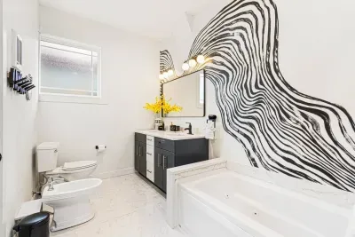 Never wait in line for the private Master ensuite bathroom while enjoying the custom mural,  melting in the jacuzzi tub and private shower.