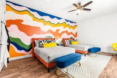 Here we have the of largest guest bedroom fitted with 2 queen beds, an inspiration custom mural, smart TV!