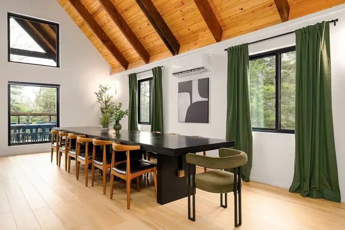 Bright dining space with vaulted wood ceilings and seating for a crowd