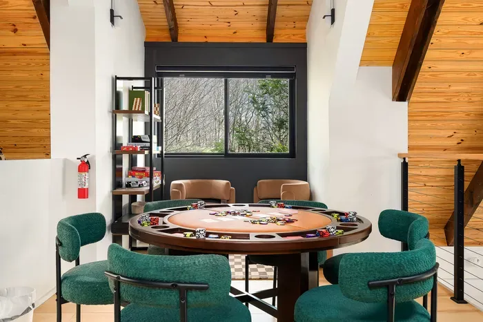 Stylish poker lounge with wooded views and cozy modern seating