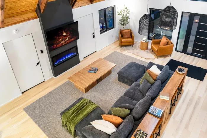 Stylish great room with soaring ceilings, fireplace, and ample seating