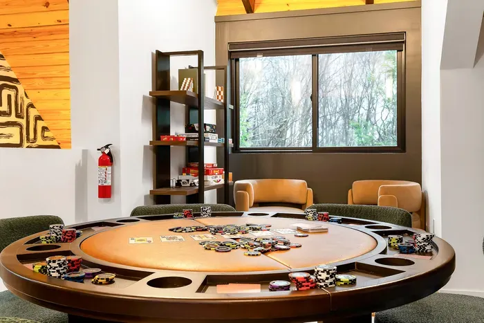 Private poker room with wooded views and cozy lounge seating