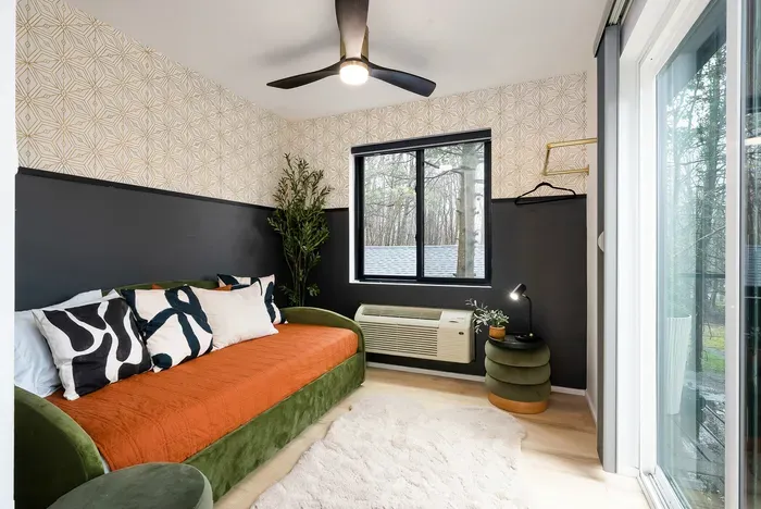 Stylish daybed nook with natural light, modern decor, and cozy touches