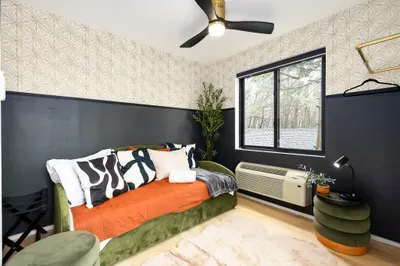 Stylish cozy bedroom with designer accents, treetop views, and natural light