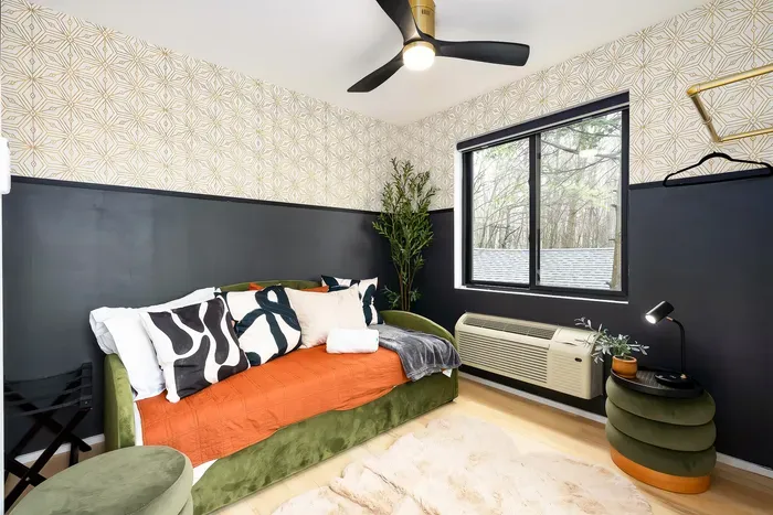Stylish cozy bedroom with designer accents, treetop views, and natural light