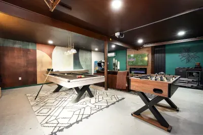 Stylish game room with pool, foosball, and a cozy lounge vibe