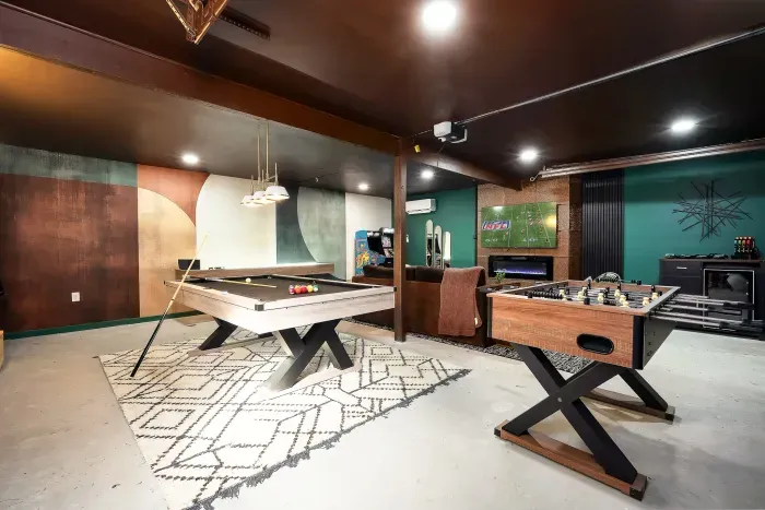 Stylish game room with pool, foosball, and a cozy lounge vibe