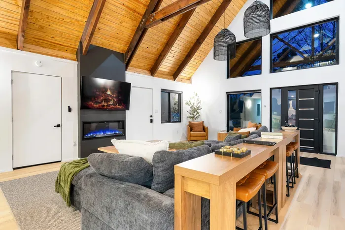 Vaulted wood ceilings, cozy fireplace, and a bright open-concept lounge