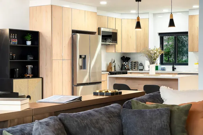 Bright modern kitchen with island seating and stylish open-plan living