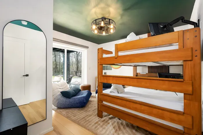 Cozy bunk room with woodland views and a bright, modern lounge nook