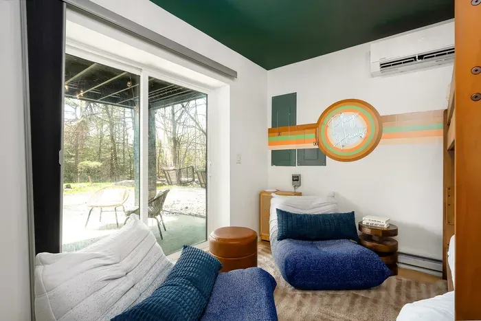 Cozy lounge nook with patio access and serene wooded views