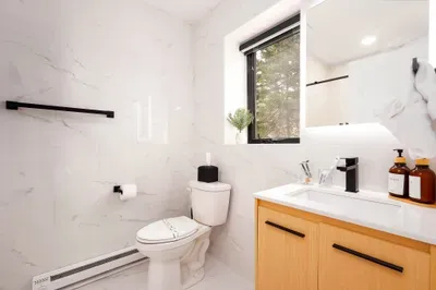 Bright modern bathroom with natural light, sleek finishes, and spa-like style