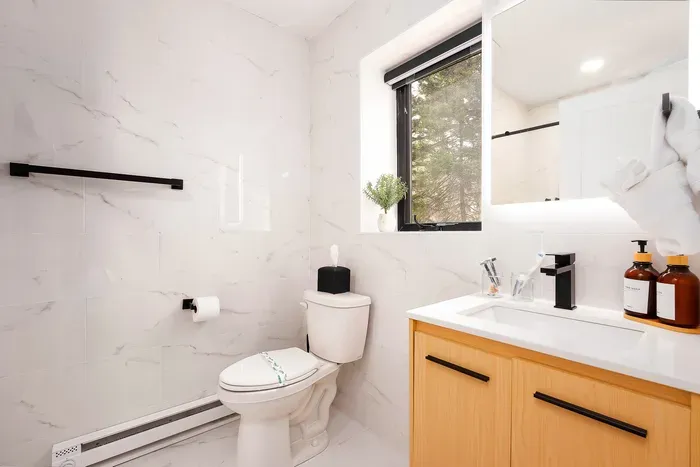 Bright modern bathroom with natural light, sleek finishes, and spa-like style