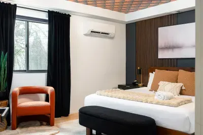 Stylish, cozy bedroom with blackout curtains, AC, and boutique design