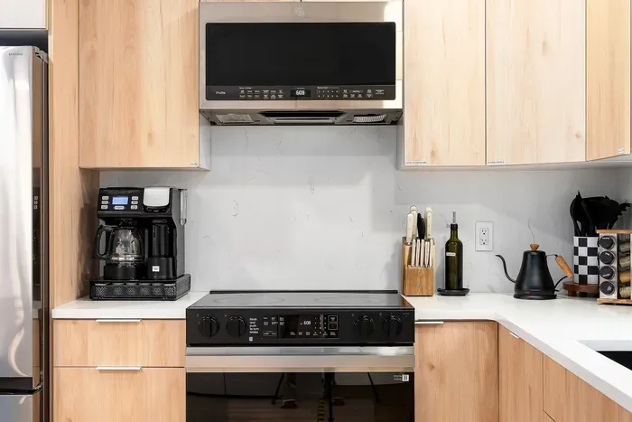 Modern, fully equipped kitchen with coffee station and sleek appliances