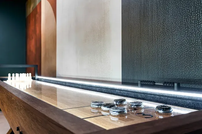 Stylish indoor shuffleboard table with modern lounge ambiance