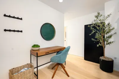 Bright modern workspace nook with stylish desk, accent chair, and storage