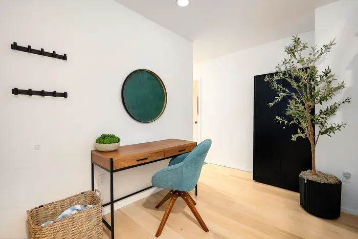 Bright modern workspace nook with stylish desk, accent chair, and storage