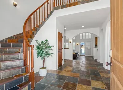 Entryway and spiral stairs to go upstairs.