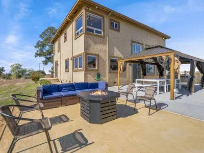 Outdoor firepit and covered dining area.