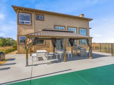Outdoor kitchen, BBQ, and dining area.