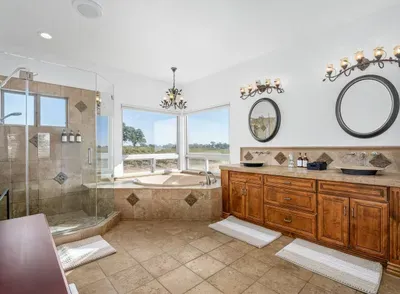 En Suite Master Bathroom with a standing shower and tub with vineyard views.