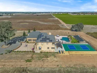 Side of home with views of backyard amenities and vineyards