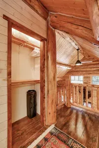 At night, the glow from the great room drifts up to the loft, giving the king suite a lantern‑low, tucked‑in feel. The closet adds nice extra storage space