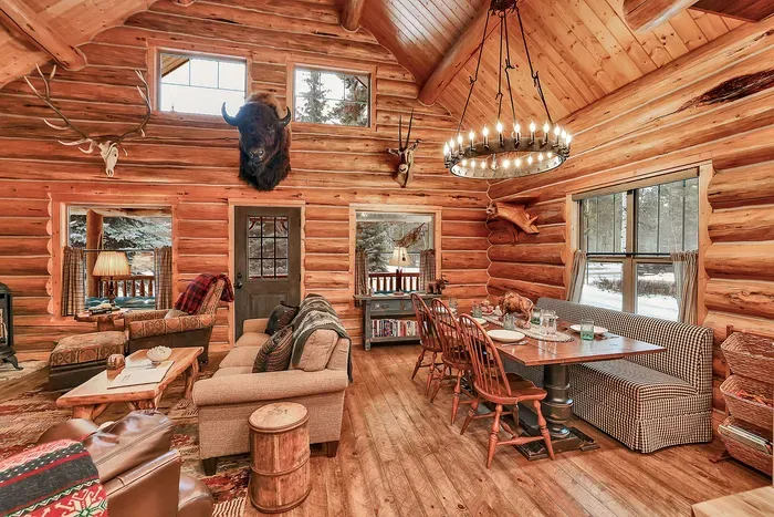 The open‑concept great room at Alder & Antler keeps everyone in the same story—cooks in the kitchen, card players at the table, and loungers by the stove