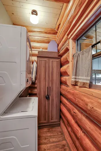 From sandy swimsuits to muddy socks, the laundry setup at Alder & Antler quietly handles the mess so the cabin can stay cozy. In addition to the stackable GE washer and dryer there's also a great space for hanging coats or wet beach towels