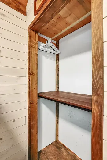 Simple, snug, and unfussy, the main‑floor guest bedroom is made for piling in—books, board games, and sleepy stories included