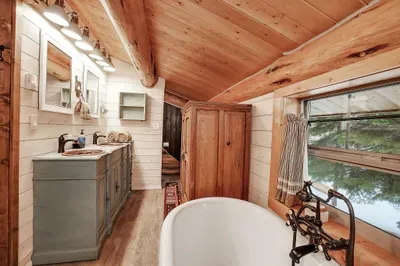 Wake to pine‑filtered light in the loft, then step straight into your own bath—no shuffle down the hall, just cabin ease