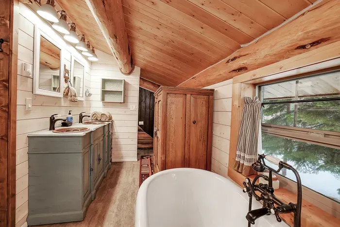Wake to pine‑filtered light in the loft, then step straight into your own bath—no shuffle down the hall, just cabin ease