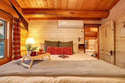 Your primary bedroom feels like a classic cabin loft—hand‑hewn beams, vaulted ceiling, and a king bed made for deep mountain sleep. Ensuite bath is super charming with dual copper sinks, a claw foot tub, and a walk-in shower