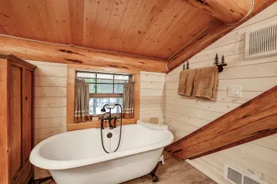 The loft bedroom and ensuite pair nostalgia with ease—classic cabin layout, with the comfort of your own bath just a few steps away