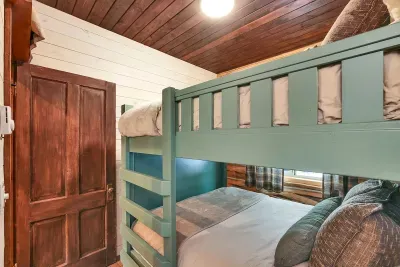 Close the door, pull the curtains, and turn the bunk room into a quiet nest after long lake days and late porch nights