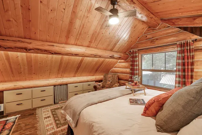 Wood grain, simple lines, and a private bath make the primary feel like your own little hideaway under the roof (6 drawers are locked for storage)
