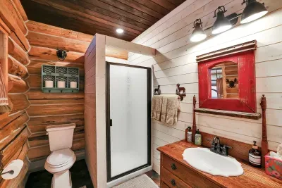 With the bunk room and great room close by, the main floor bath quietly does its job—rinsing off dusty kids and tired hikers. Hot water, soft towels, and straightforward finishes make this bathroom a no‑fuss landing spot between porch time and town