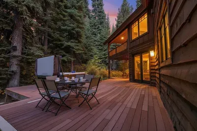Wraparound deck that circles the house in trees and mountain air.