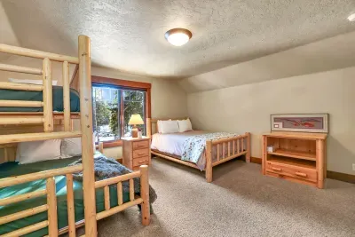 Apartment bedroom with queen bed and twin-over-queen bunk—sleep 4–5 comfortably
