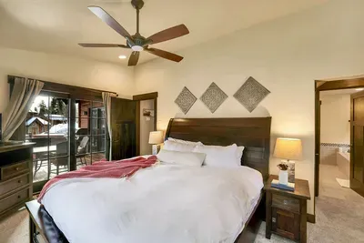 Primary bedroom on the main floor with a comfy king bed and simple mountain style