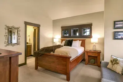 Upstairs guest room with a queen bed and plenty of natural light.